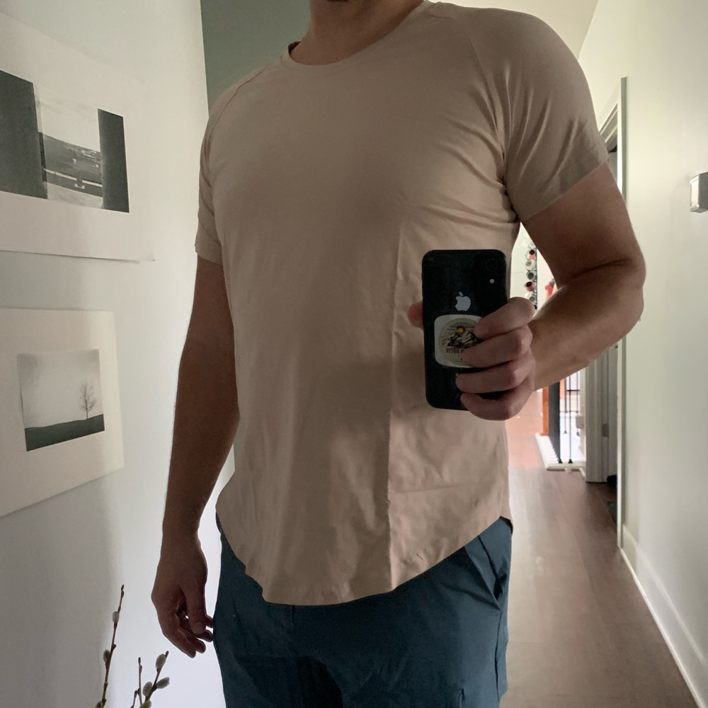 Tan tee with drop cut and swoop bottom.